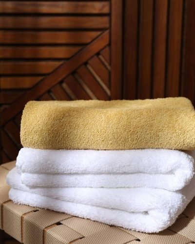 imgi 55 stacked soft towels wicker bench indoors 495423 71453